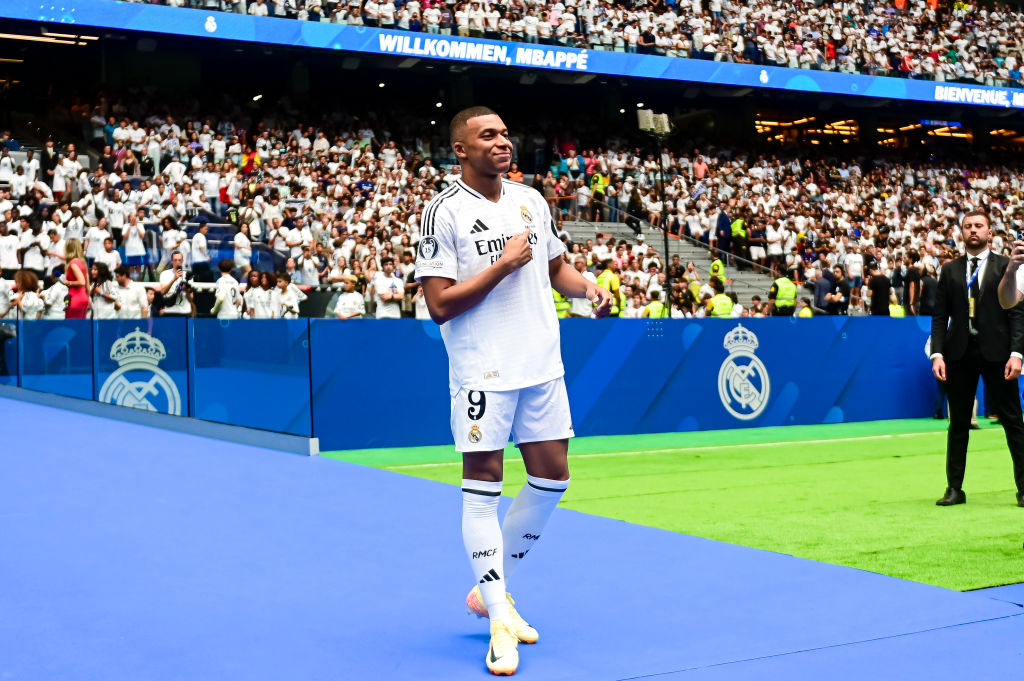 MADRID, SPAIN - JULY 16: Kylian Mbappe poses for photos with Real Madrid jersey while is presented for supporters at Estadio Santiago Bernabeu on July 16, 2024 in Madrid, Spain. (Photo by Alberto Gardin/Eurasia Sport Images/Getty Images)