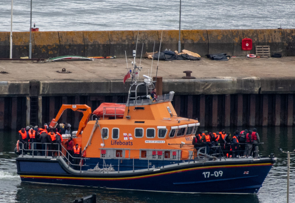 DOVER, ENGLAND - APRIL 23: Migrants are brought into Dover Port by a RNLI lifeboat after being picked up in the English Channel while trying to make the journey from France in inflatable dinghies on April 23, 2024 in Dover, England. At least five migrants are reported to have died whilst crossing the Channel in small boats from France this morning. Last night the UK government's Safety Of Rwanda Bill finally completed its passage through parliament. (Photo by Chris J Ratcliffe/Getty Images)