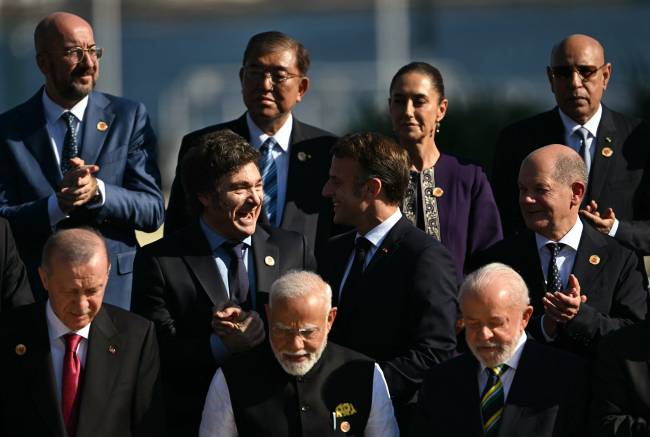 (L to R, front row) Turkey's President Recep Tayyip Erdogan, India's Prime Minister Narendra Modi, Brazil's President Luiz Inacio Lula da Silva, (middle row) Argentina's President Javier Milei, France's President Emmanuel Macron, Germany's Chancellor Olaf Scholz, (back row) the president of the European Council Charles Michel, Japan's Prime Minister Shigeru Ishiba, Mexico's President Claudia Sheinbaum, and Mauritania's President and president of the African Union Mohamed Ould Ghazouani pose for a group photo after the first session of the G20 Leaders' Meeting in Rio de Janeiro, Brazil, on November 18, 2024. (Photo by Mauro PIMENTEL / AFP)