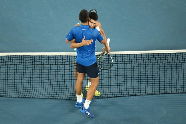 2025 Australian Open – Day 10 MELBOURNE, AUSTRALIA - JANUARY 21: Novak Djokovic of Serbia embraces Carlos Alcaraz of Spain following victory in the Men's Singles Quarterfinal match during day 10 of the 2025 Australian Open at Melbourne Park on January 21, 2025 in Melbourne, Australia. (Photo by Quinn Rooney/Getty Images)
