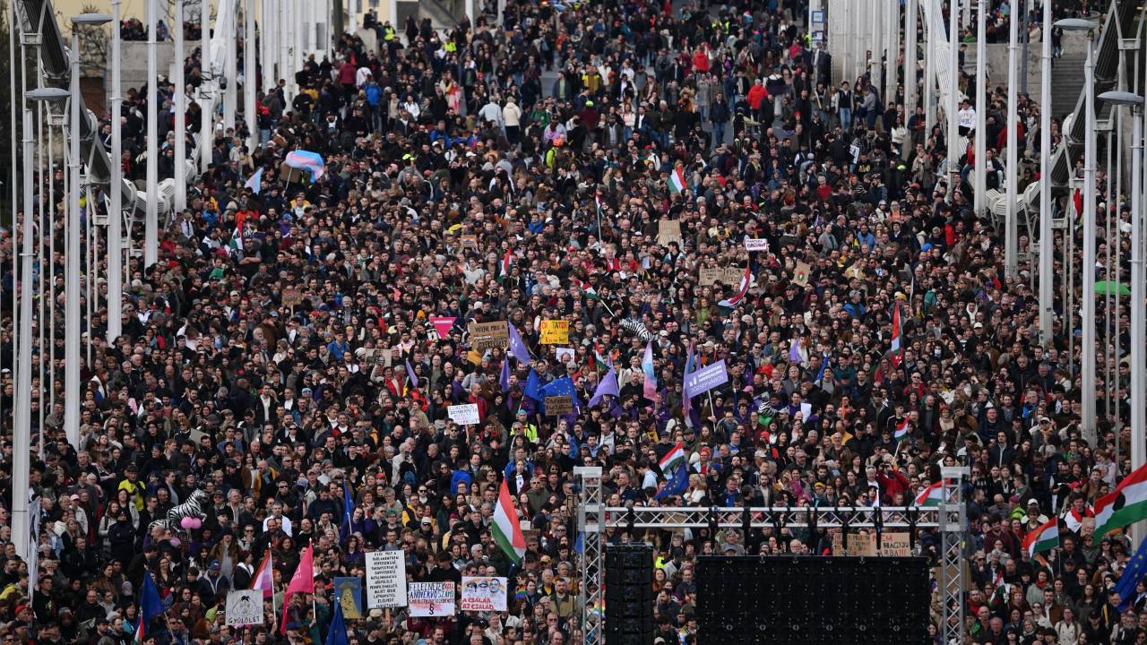 Protesters take part in a rally on the Erzsebet (Elisabet) Bridge in Budapest on April 1, 2025 against the government's efforts to restrict the freedom of assembly and expand its surveillance powers. Hungarian lawmakers passed legislation on March 18, 2025 aimed at banning the annual Pride march and other demonstrations, enabling the use of facial recognition tools to identify participants of banned demonstrations. (Photo by Attila KISBENEDEK / AFP)