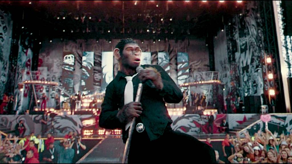 Crédito: Divulgação- – – OUSADO - Robbie Williams: cantor surge como um macaco e expõe seus dramas