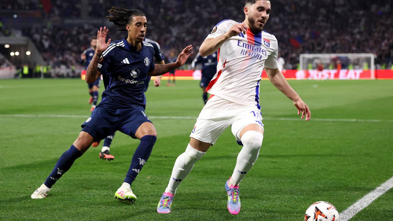 DECINES-CHARPIEU, FRANCE - APRIL 10: Rayan Cherki of Olympique Lyonnais chases the ball to the touchline whilst under pressure from Leny Yoro of Manchester United during the UEFA Europa League 2024/25 Quarter Final First Leg match between Olympique Lyonnais and Manchester United at OL Stadium on April 10, 2025 in Decines-Charpieu, France. (Photo by Michael Steele/Getty Images)