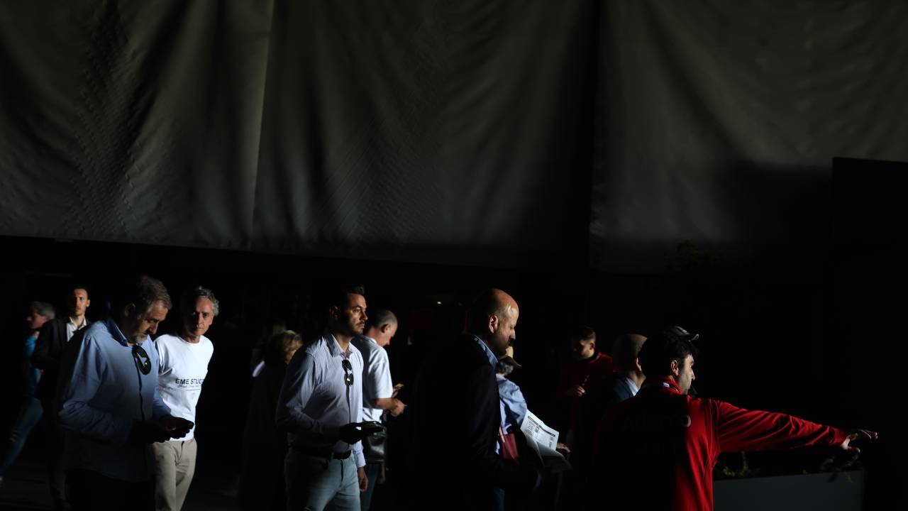 MADRID, SPAIN - APRIL 28: Fans walk through the dark gangways during a general power blackout during Day Seven of the Mutua Madrid Open at La Caja Magica on April 28, 2025 in Madrid, Spain. A widespread power outage hit Spain, Portugal and parts of France.