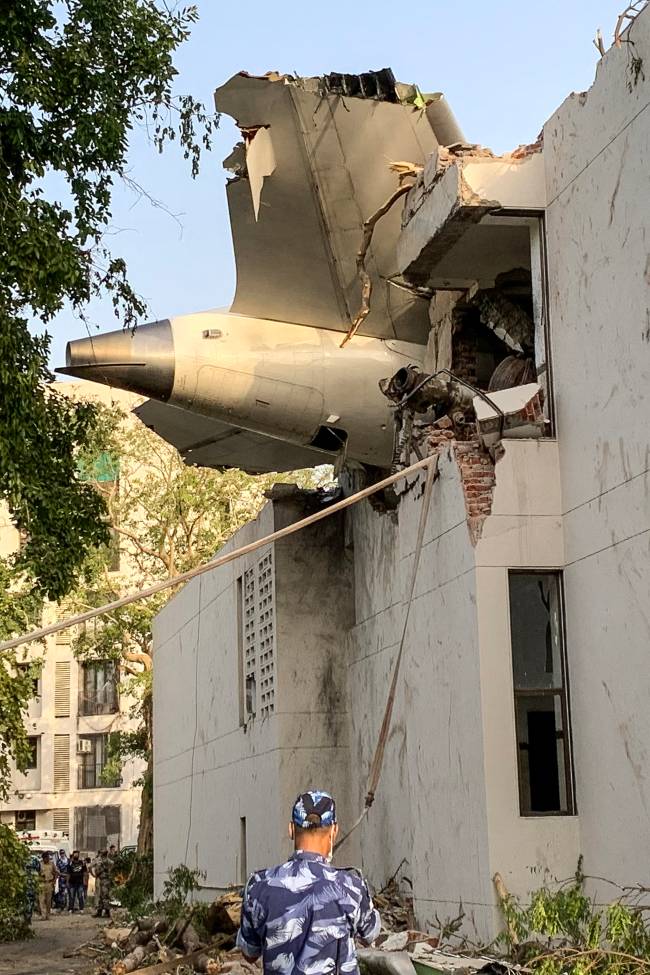 INDIA-AVIATION-CRASH The back of Air India flight 171 is pictured at the site after it crashed in a residential area near the airport in Ahmedabad on June 12, 2025. A London-bound passenger plane crashed in the Indian city of Ahmedabad on June 12 and all 242 people on board were believed killed, with the jet smashing into buildings housing doctors and their families. (Photo by Sam PANTHAKY / AFP)