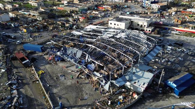 An aerial view shows destroyed buildings following the passage of Hurricane Melissa in Black River, St. Elizabeth, Jamaica, on October 29, 2025. Hurricane Melissa bore down on the Bahamas October 29 after cutting a path of destruction through the Caribbean, leaving 30 people dead or missing in Haiti and parts of Jamaica and Cuba in ruins. Somewhat weakened but still threatening, Melissa will bring damaging winds and flooding rains to the Bahamas Wednesday before moving on to Bermuda late Thursday, according to the US National Hurricane Center (NHC). (Photo by Ricardo Makyn / AFP)