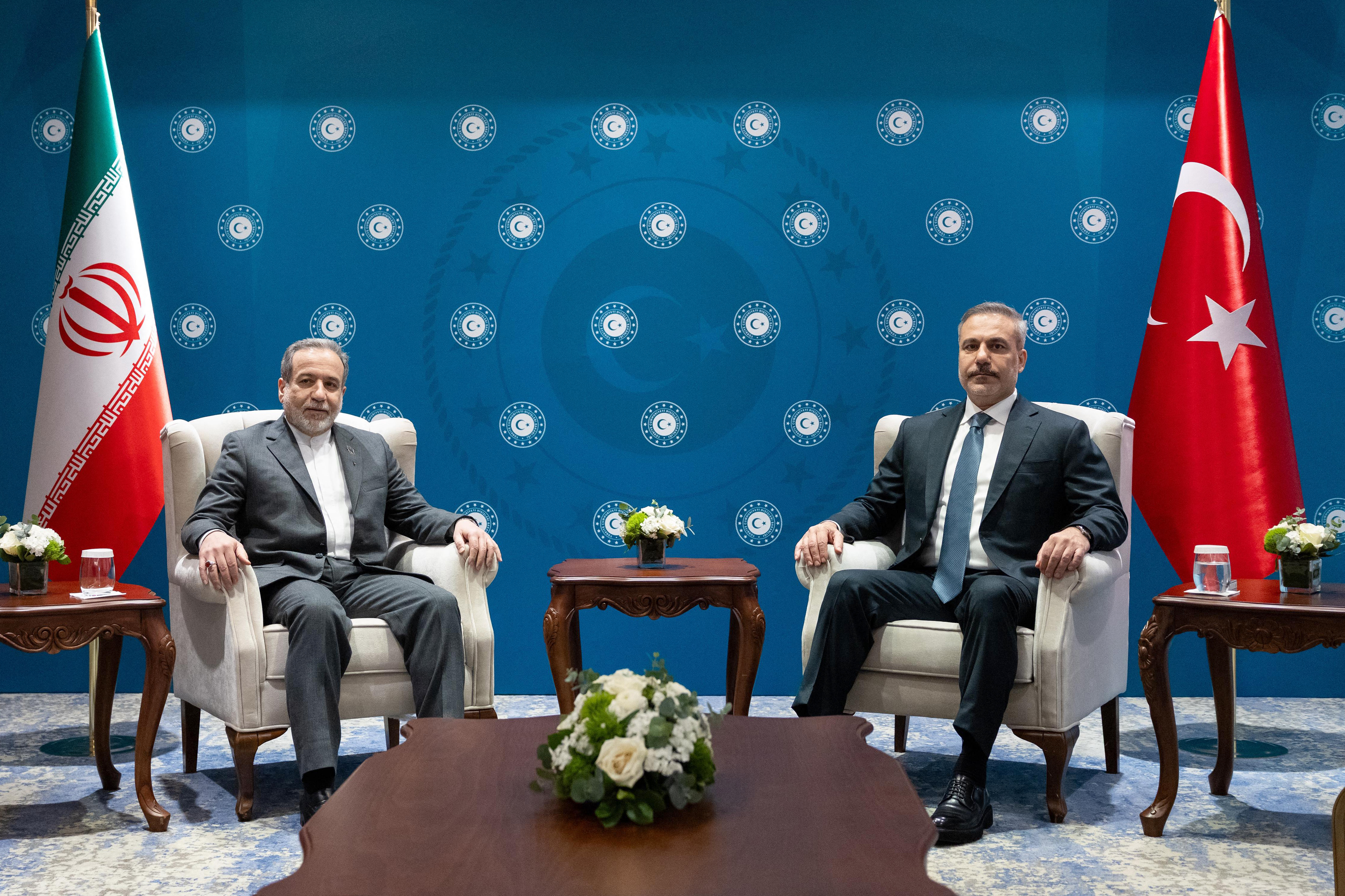 This handout photograph taken and released by the Turkish Foreign Ministry press service on January 30, 2026 shows Turkish Foreign Minister Hakan Fidan (R) meeting with Iran's Foreign Minister Abbas Araqchi (L) in Istanbul. Iran's foreign minister was in Turkey today as Ankara led a diplomatic push to mediate between Tehran and Washington, after US President cooled threats of an imminent strike on the Islamic republic. (Photo by Handout / TURKISH FOREIGN MINISTRY / AFP) / RESTRICTED TO EDITORIAL USE - MANDATORY CREDIT "AFP PHOTO / TURKISH FOREIGN MINISTRY" - NO MARKETING - NO ADVERTISING CAMPAIGNS - DISTRIBUTED AS A SERVICE TO CLIENTS