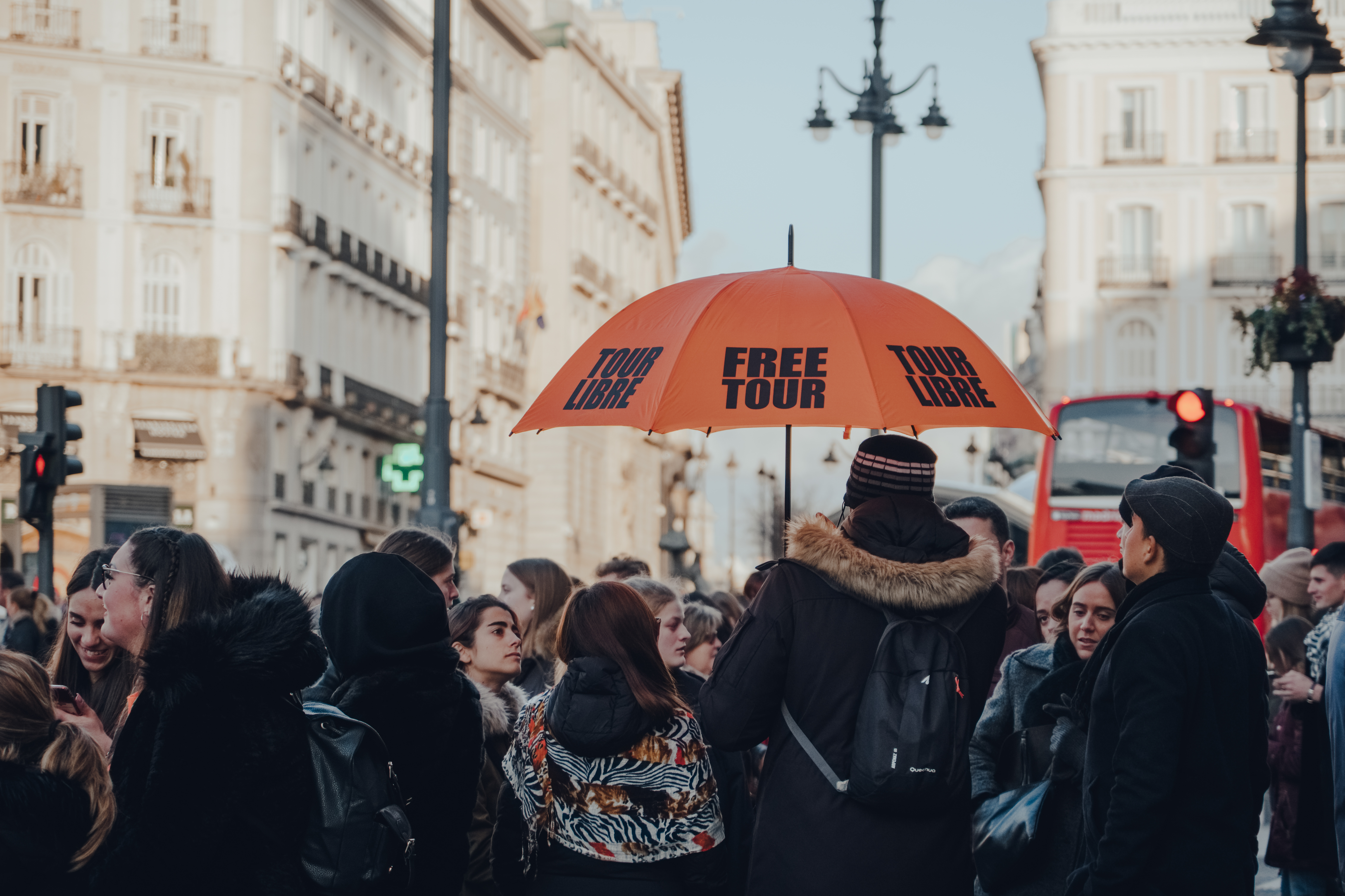 Group of tourists gathered on Puerta del Sol, Madrid Spain, for a free guided tour.